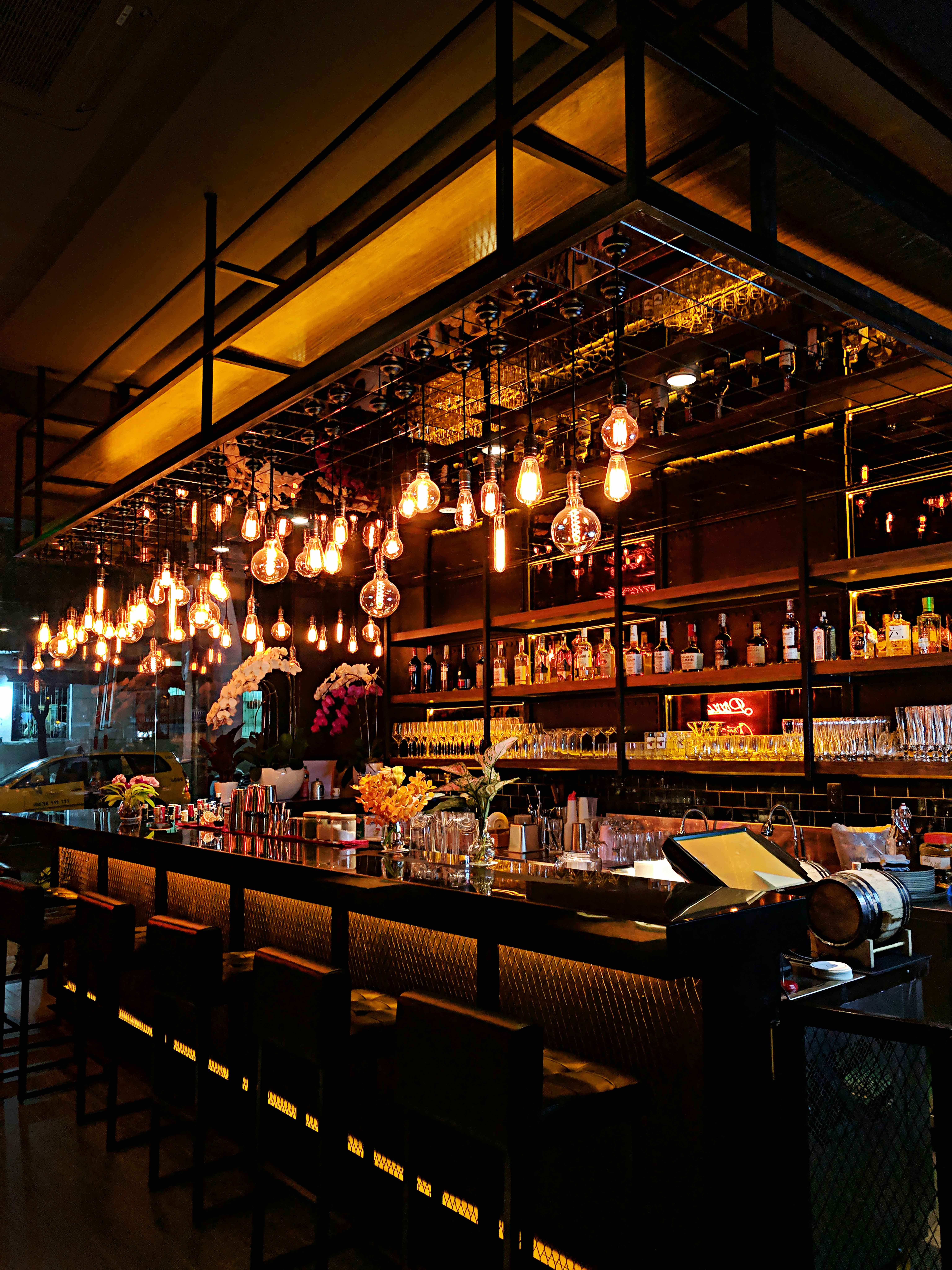 Elegant modern bar with wooden counter and stylish lighting